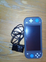 Nintendo Switch Lite with games cases controller