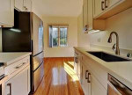 A clean, retro two-bedroom, one bath house with carport, small fenced