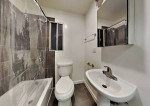 A clean, retro two-bedroom, one bath house with carport, small fenced