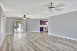 HOME, SITUATED ON A FENCED LOT WITH A SOLAR HEATED POOL NEW FLOORS +