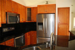 HOME WITH STAINLESS STEEL APPLIANCES. TILE & WOOD FLOORING IN BEDROOMS