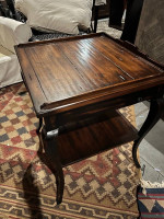 A beautiful high end hooker side table with a shelf and drawer