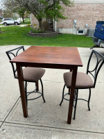 High table and swivel chairs