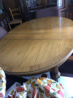 Wood dining table 42” has one leaf