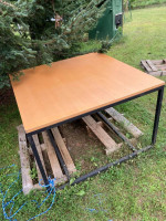 Large square table. Black metal base. Good condition