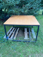 Large square table. Black metal base. Good condition