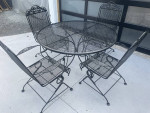 Classic wrought iron patio set. Dining table and four chairs