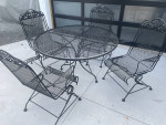 Classic wrought iron patio set. Dining table and four chairs