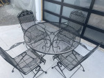 Classic wrought iron patio set. Dining table with four chairs