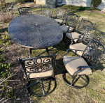 Like NEW- Cast aluminum 9 piece outdoor dining table, 8 swivel chairs w cushions