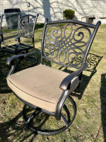 Like NEW- Cast aluminum 9 piece outdoor dining table, 8 swivel chairs w cushions