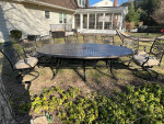 Like NEW- Cast aluminum 9 piece outdoor dining table, 8 swivel chairs w cushions