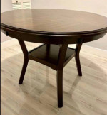 round wooden table and two swivel chairs