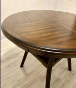round wooden table and two swivel chairs
