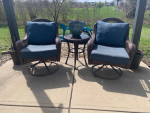 2 outdoor swivel chairs and table