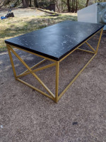 Metal coffee table with synthetic top