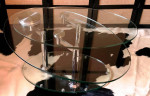 AMBER OVAL GLASS MOTION COCKTAIL TABLE