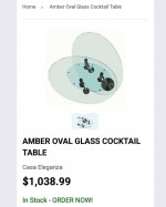 AMBER OVAL GLASS MOTION COCKTAIL TABLE