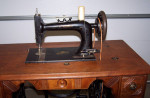 1889 New Home Cast Iron Treadle Sewing Machine Walnut Coffin Top Table