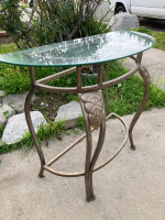 Glass top metal entry half against the wall table