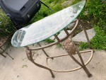 Glass top metal entry half against the wall table