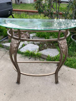 Glass top metal entry half against the wall table