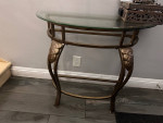Glass top metal entry half against the wall table