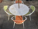 An outdoor set of 44-inch round table and four chairs