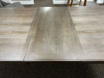 Grey wood table with extendable leaf