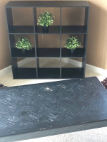 Cubby bookshelf; black coffee table; brown coffee table