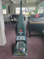 Small wooden table and bissell vacuum cleaner