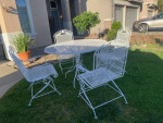 Wrought Iron Table and 4 Rocking Chairs