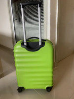 Bright green American Tourister suitcase