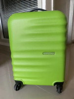 Bright green American Tourister suitcase