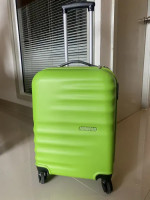 Bright green American Tourister suitcase