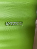 Bright green American Tourister suitcase