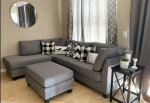 Brand new grey linen Sectional Sofa with ottoman and 2 accent pillows.