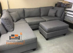 Brand new grey linen Sectional Sofa with ottoman and 2 accent pillows.