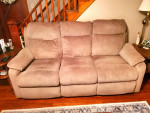 Power reclining sofa with power headrest