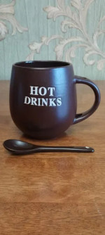 Mug with a spoon for hot drinks