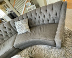 curved sofa tufted couch gray taupe storage ottoman and  pillows