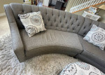 curved sofa tufted couch gray taupe storage ottoman and  pillows