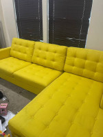 Yellow sectional sofa with pillows and accessories