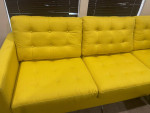 Yellow sectional sofa with pillows and accessories