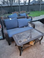 Blue backyard sofa and swivel chairs, glass table