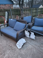 Blue backyard sofa and swivel chairs, glass table