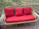 wicker sofa with red cushions