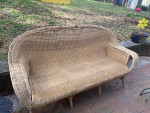 wicker sofa with red cushions