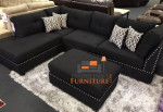 black linen Sectional Sofa with ottoman and 2 accent pillows.