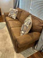 Matching taupe/light brown faux leather nailhead sofa and rocking recl